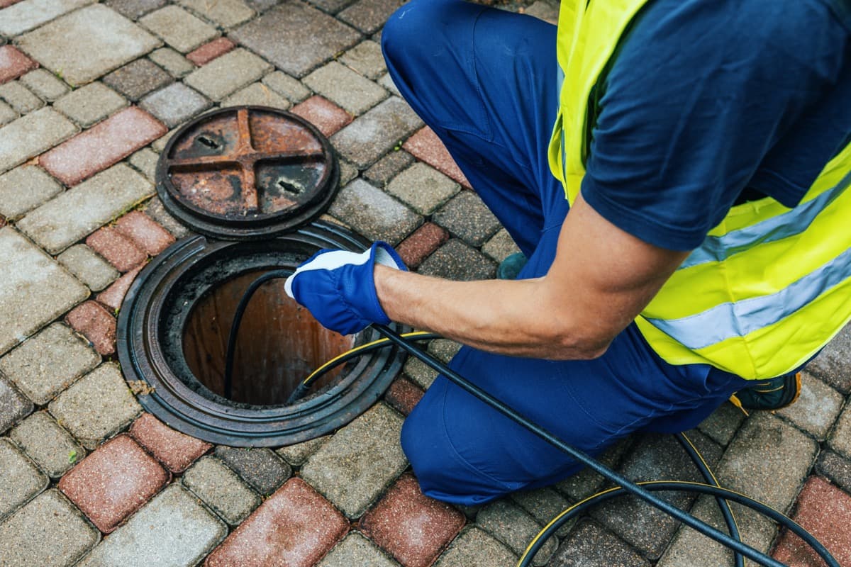 A vetted field technician performing documented drainage work for USA Jetting.
